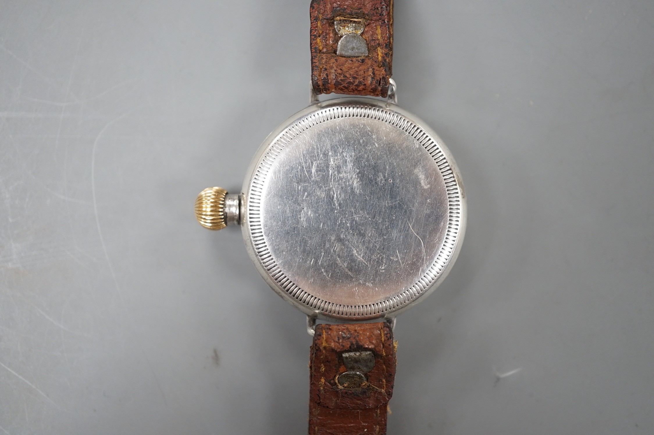 A gentleman's early 20th century silver manual wind wrist watch with Zenith movement, on associated leather strap.